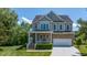 Attractive two-story home with a stone facade and inviting front porch at 9701 Corktree Ct, Wake Forest, NC 27587