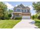 Beautiful two-story home with stone accents, covered porch, and well-maintained front lawn at 9701 Corktree Ct, Wake Forest, NC 27587