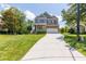 Two-story home with stone accents, a covered porch, attached garage, and manicured lawn at 9701 Corktree Ct, Wake Forest, NC 27587