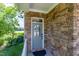 Stone facade with front door overlooking the flowers and lake at 9701 Corktree Ct, Wake Forest, NC 27587