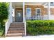 Welcoming front porch with stone accents and brick steps, perfect for relaxation at 9701 Corktree Ct, Wake Forest, NC 27587