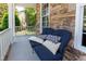 Cozy front porch featuring a comfortable blue sofa with decorative pillows at 9701 Corktree Ct, Wake Forest, NC 27587