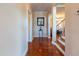 Hallway featuring hardwood floors, staircase access, and neutral color scheme at 9701 Corktree Ct, Wake Forest, NC 27587