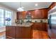 A luxury kitchen featuring wooden cabinets, granite countertops, and stainless steel appliances at 9701 Corktree Ct, Wake Forest, NC 27587