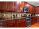 Kitchen features wooden cabinetry, granite countertops, stainless steel oven and microwave at 9701 Corktree Ct, Wake Forest, NC 27587