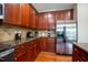 Kitchen features wooden cabinets, granite countertops, and stainless steel refrigerator at 9701 Corktree Ct, Wake Forest, NC 27587