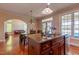 Kitchen with wooden cabinets, granite countertops, and stainless steel appliances and a view into living room at 9701 Corktree Ct, Wake Forest, NC 27587