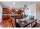 Open kitchen view with wooden dining table, stainless steel appliances, and granite countertops at 9701 Corktree Ct, Wake Forest, NC 27587