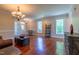 Inviting living room with hardwood floors, lots of windows, and a decorative chandelier at 9701 Corktree Ct, Wake Forest, NC 27587