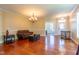 Spacious living room featuring a chandelier, hardwood floors, and ample natural light at 9701 Corktree Ct, Wake Forest, NC 27587