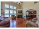 Spacious living room featuring a stone fireplace, large windows with scenic views, and comfortable furnishings at 9701 Corktree Ct, Wake Forest, NC 27587
