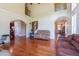 Expansive living room with hardwood floors, and an open layout with staircase access at 9701 Corktree Ct, Wake Forest, NC 27587