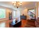 Open living room with hardwood floors, chandelier, and staircase access at 9701 Corktree Ct, Wake Forest, NC 27587