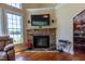 The living room features a stone fireplace and views of the lake at 9701 Corktree Ct, Wake Forest, NC 27587
