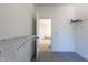 Bright walk-in closet featuring carpeted floors and wire shelving leading to a bright bathroom with a soaking tub at 9701 Corktree Ct, Wake Forest, NC 27587