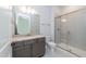 Modern bathroom featuring a gray vanity, granite countertop, and a glass-enclosed shower with tiled walls at 0 Bluestone Ct # 22 R, Chapel Hill, NC 27514