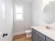 Elegant half bathroom featuring modern vanity with a white countertop, and a round mirror at 0 Bluestone Ct # 22 R, Chapel Hill, NC 27514