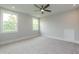 This airy bedroom features two windows, soft grey carpet, and a ceiling fan at 0 Bluestone Ct # 22 R, Chapel Hill, NC 27514