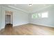 Bright bedroom features hardwood floors, large windows, and neutral paint; ready for personalization at 0 Bluestone Ct # 22 R, Chapel Hill, NC 27514