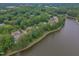 Aerial view of homes nestled in a community with mature trees, walking trails and lake views at 0317 Glen Echo Ln # C, Cary, NC 27518