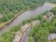 Aerial view of waterfront condos with lush green landscaping, sidewalks, and dedicated parking at 0317 Glen Echo Ln # C, Cary, NC 27518