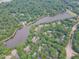 Aerial view of a residential community featuring lake access, lush landscaping, and mature trees at 0317 Glen Echo Ln # C, Cary, NC 27518