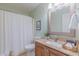 Well-lit bathroom features a single vanity, granite countertop, framed mirror, and shower with white curtain at 0317 Glen Echo Ln # C, Cary, NC 27518