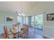 Cozy dining area with chandelier and sliding glass doors that lead to an outdoor balcony at 0317 Glen Echo Ln # C, Cary, NC 27518