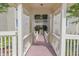 Hallway view showcasing stairs with wooden railing and overhead roofing at 0317 Glen Echo Ln # C, Cary, NC 27518