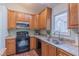 Updated kitchen featuring granite countertops, stainless appliances, and ample storage space at 0317 Glen Echo Ln # C, Cary, NC 27518