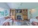 Inviting living room with stone fireplace, custom built-ins, hardwood floors, and large windows with views at 0317 Glen Echo Ln # C, Cary, NC 27518