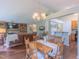 Open-concept living and dining area with wood floors, vaulted ceilings, and a stone fireplace at 0317 Glen Echo Ln # C, Cary, NC 27518