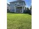 Spacious backyard with a well-maintained lawn and a covered patio area for outdoor enjoyment at 109 E Webber Lane Ln, Clayton, NC 27527
