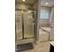 Bright bathroom featuring a glass-enclosed shower and separate soaking tub by the window at 109 E Webber Lane Ln, Clayton, NC 27527
