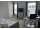 Bright bedroom featuring two windows, a ceiling fan, a workspace, and a daybed at 109 E Webber Lane Ln, Clayton, NC 27527
