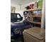 Spacious garage featuring a blue Jeep, overhead storage, and recycling bins at 109 E Webber Lane Ln, Clayton, NC 27527