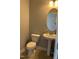 Neat half bathroom features a pedestal sink, oval mirror, and efficient use of space at 109 E Webber Lane Ln, Clayton, NC 27527