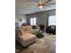 Bright living room with a large sectional sofa, round coffee table, and a dining area in the background at 109 E Webber Lane Ln, Clayton, NC 27527