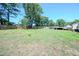 Expansive backyard features a large lawn, mature trees, and privacy fencing at 111 Marshay Meadow Rd, Youngsville, NC 27596