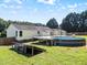Backyard featuring an above-ground pool, wooden deck, and exterior of the house at 111 Marshay Meadow Rd, Youngsville, NC 27596