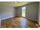Comfortable bedroom featuring hardwood floors and a bright window at 111 Marshay Meadow Rd, Youngsville, NC 27596