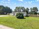 Scenic view of house with basketball court, storage shed, large front yard and wood fence at 111 Marshay Meadow Rd, Youngsville, NC 27596