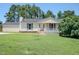 Charming home featuring a classic front porch and a well-maintained lawn at 111 Marshay Meadow Rd, Youngsville, NC 27596