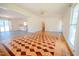 Bright living room showcasing unique parquet floors and lots of natural light at 111 Marshay Meadow Rd, Youngsville, NC 27596