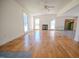 Bright living room with a fireplace, large windows, and unique patterned wood flooring at 111 Marshay Meadow Rd, Youngsville, NC 27596
