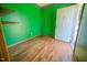 Study has bright green walls and laminate wood flooring at 111 Marshay Meadow Rd, Youngsville, NC 27596