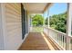 Inviting front porch with wood flooring and white railing offering serene views at 111 Marshay Meadow Rd, Youngsville, NC 27596