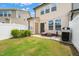 Outdoor patio with a grill and cozy seating, surrounded by a well-maintained yard and white fence at 1137 Amber Shadow Dr, Durham, NC 27703