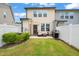 Outdoor patio with a grill and cozy seating, surrounded by a well-maintained yard and white fence at 1137 Amber Shadow Dr, Durham, NC 27703