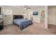 Comfortable bedroom features carpet, ceiling fan, tv and view to the Primary bathroom at 1137 Amber Shadow Dr, Durham, NC 27703